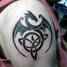 a man with a dragon tattoo on his shoulder