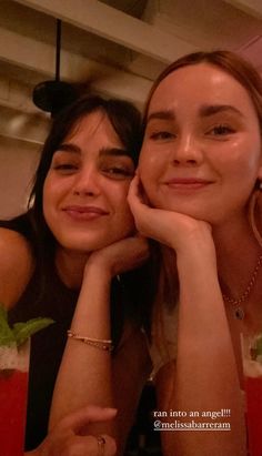 two women sitting next to each other at a table