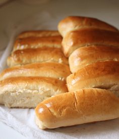 several loaves of bread sitting on top of a white paper towel next to each other