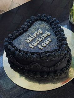 a heart shaped birthday cake on a table