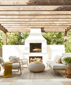 an outdoor living area with furniture and a fire place