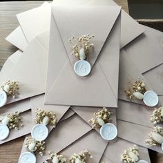 several envelopes with buttons and flowers on them