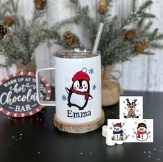 personalized christmas mugs and coasters on a table with pine cones in the background