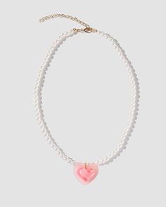 Details: Pearl necklace with front pink heart design Cute Heart Shaped Clavicle Chain, Cute Heart-shaped Clavicle Chain, Cute Heart Shaped Clavicle Chain Jewelry, Pink Heart Pendant Charm Necklace, Pink Heart Pendant Charm Necklace With Clavicle Chain, Pink Heart Pendant Charm Necklace On Clavicle-length Chain, Pink Clavicle Chain Necklace For Valentine's Day, Cute Pink Clavicle Chain Jewelry, Pink Heart Charm Pendant Jewelry