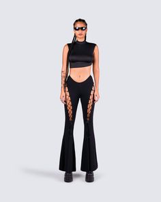 An all-black fit always exudes a "don't mess with me" kind of vibe 😈 Intimidate and entice them all with this 2 piece set, featuring a black turtleneck crop top, paired with black lace-up flared pants 🖤 Edgy High Stretch Crop Top For Night Out, Edgy High-stretch Crop Top For Night Out, Edgy Cropped Stretch Bottoms, Black Cropped Bottoms For Party, Cropped Black Bottoms For Party, Trendy Cropped Pants For Night Out, Trendy Cropped Pants For Party, Black Cropped Bottoms For Streetwear, Black Cropped Streetwear Bottoms