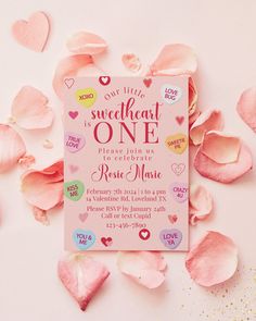 a pink birthday card surrounded by petals and confetti on a white background with the words sweet heart is one