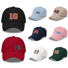 "Include the number of your favorite professional, college or varsity sports player on this custom number dad hat. It features a stylish, low-profile design and is available in 11 different colors with 15 embroidery stitch color options. Add your favorite hockey, football, soccer, baseball, racing or sports player number in the team colors of your choice. THIS IS A CUSTOM PRODUCT AND RETURNS ARE NOT ACCEPTED. PLEASE SELECT YOUR OPTIONS CAREFULLY. A MOCKUP WILL BE PROVIDED FOR YOUR APPROVAL BEFOR Collegiate Six-panel Dad Hat For Baseball Season, College Dad Hat For Baseball Season With Curved Visor, Curved Visor Dad Hat For College Baseball Season, College Baseball Cap With Letter Print For Baseball Season, Curved Bill Dad Hat For Baseball Season, Six-panel Dad Hat For Baseball Season Sports Events, Sporty Dad Hat With Curved Bill For Game Day, Six-panel Dad Hat For Baseball Season, Sporty Dad Hat For College Baseball Season