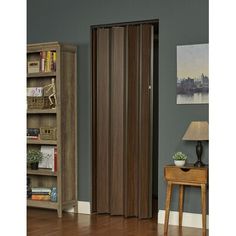 a room with a book shelf and a wooden door