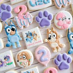 decorated cookies are arranged on a wooden surface with the letters and numbers for each cookie