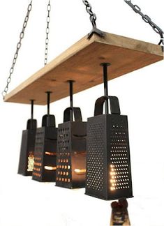 a wooden light fixture with four lights hanging from it