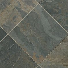 a tile floor that is made out of different types of slates and has an interesting pattern