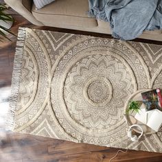 a living room with a couch and rug on the floor