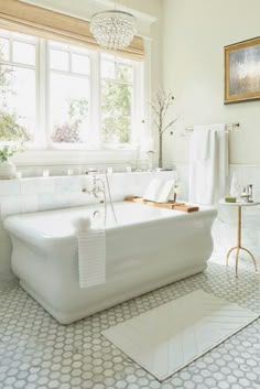 a white bath tub sitting next to a window