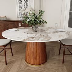 a marble dining table with two chairs around it