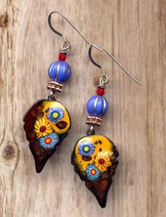 "Handmade Enamel Leaf Earrings, Leaves Blue Orange Sterling Silver Enamel Earrings, Royal Fall Foliage, Cooper Boho Jewelry by Annaart72 Materials handmade by me one of a kind enamel charms Czech glass beads with sterling silver ear wire cooper findings Bohemian and classy, this one of a kind fall foliage leaf enamel pair is 2.5\" long, comfy to wear weight wise, not heavy at all but offers lots of colors and whimsy Your enamel blue orange leaf earrings will come in a gift box For more unique en Multicolor Enamel Jewelry With Ear Wire, Multicolor Teardrop Enamel Jewelry, Multicolor Enamel Teardrop Jewelry, Bohemian Blue Enamel Earrings, Artistic Yellow Teardrop Jewelry, Antler Pendant, Aqua Earrings, Rose Quartz Earrings, Surgical Steel Earrings