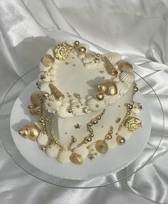 a white cake with gold decorations on it