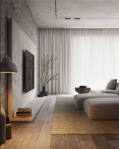 a modern living room with wood flooring and white curtains