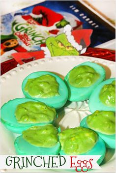 green deviled eggs on a white plate with the words grin - eyed eggs above them