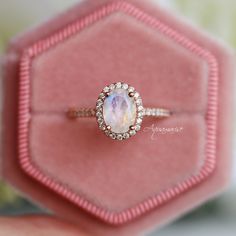 Gorgeous Rainbow Moonstone Ring ►Base Metal: Sterling Silver ►Plating: 14K Rose Gold Vermeil (S925) ►Accented with Simulated Diamonds (CZ) Center Stone: Moonstone Color: Rainbow Stone Cut: Oval Gem size: 8.0 x 6.0 mm Carat Weight: 1.21 ct. (approx.) Gemstone creation: Natural ►This ring can be paired with one or two matching Milgrain bands of your choice (select option from the drop-down menu). ►Handling time: 1-3 business days ►Free domestic shipping. Usually takes 2-5 business days. ►Wrapped & Rose Gold Round Moonstone Ring With Halo, Rose Gold Moonstone Halo Promise Ring, Rose Gold Halo Jewelry For Proposal, Rose Gold Celestial Moonstone Ring For Anniversary, Celestial Rose Gold Moonstone Ring For Anniversary, Rose Gold Moonstone Ring For Promise, Rose Gold Moonstone Ring For Anniversary, Celestial Rose Gold Gemstone Rings, 14k Rose Gold Halo Jewelry Gift