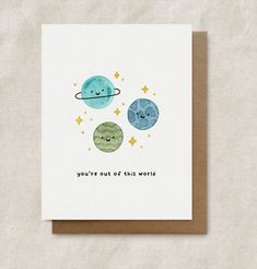 a card with the words you're out of this world on it and two planets