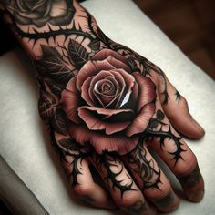 a hand with a rose tattoo on it