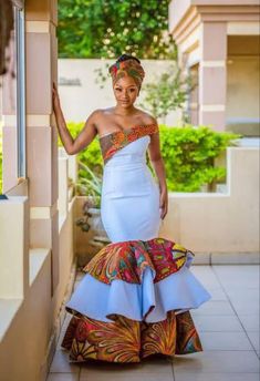 a woman in a white dress is posing for the camera