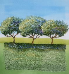 three trees in the middle of a green field