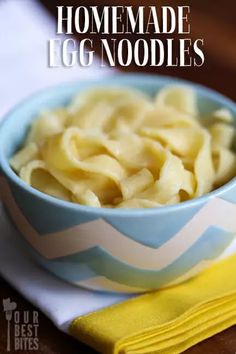 homemade egg noodles in a blue and white bowl on top of a yellow napkin