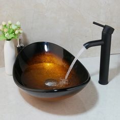 a black bowl sink sitting next to a faucet