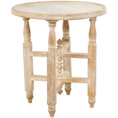 a white table with wooden legs and a round top