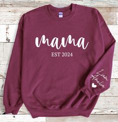 Celebrate the special bond between a mother and her children with this personalized Gildan Sweatshirt featuring the endearing design of Mama with the kids' names beautifully displayed on the sleeve. This thoughtful and heartwarming gift is perfect for Mother's Day, Mom's birthday, or any occasion to show your love and appreciation. Made with high-quality material, this sweatshirt is both stylish and comfortable, making it a meaningful and cherished addition to any mom's wardrobe. Customize it wi Father's Day White Sweatshirt Gift, Family Matching Sweatshirt With Letter Print As Gift, Family Matching Letter Print Sweatshirt As Gift, Family Matching Sweatshirt With Letter Print, Mother's Day Family Matching Crew Neck Sweatshirt, Family Matching Crew Neck Sweatshirt For Mother's Day, Personalized Long Sleeve T-shirt For Mother's Day, Custom Text Long Sleeve Tops For Gifts, Personalized Long Sleeve Sweatshirt For Mother's Day