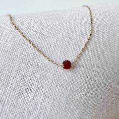 This genuine faceted ruby sits on a dainty chain that lays below the collarbone. A simple necklace that is perfect by itself or layered with other necklaces. Ruby is the birthstone for July.  The length on the model is 16 inches. Jewelry is handmade by us in NYC focusing on quality using only the highest quality materials and handpicked genuine gemstones.   ▹ PACKAGING All jewelry is beautifully wrapped in tissue and placed in a kraft box with a card inside a logo drawstring pouch. This makes for great gift giving.  ▹ F A Q  What is 14k Gold-Filled?  Gold-filled is the next best option to 14k solid gold. It is a less expensive option and it is hypoallergenic. Gold-filled is actual 14k gold heat-bonded with an inner core of brass as opposed to gold plated which is a thin layer of gold liqui Minimalist Ruby Birthstone Necklace, Dainty Ruby Birthstone Necklace, Red Minimalist Birthstone Necklace, Gift Ruby Necklace With Delicate Chain, Ruby Necklace With Delicate Chain For Gift, Ruby Necklace With Delicate Chain As Gift, Dainty Ruby Necklaces, Real Ruby Necklace, Necklace Ruby