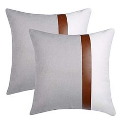 two white pillows with brown stripes on them