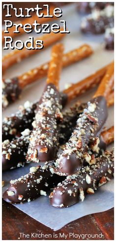 chocolate covered pretzel rods with nuts on top