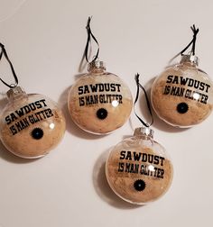 three glass baubles with sayings on them