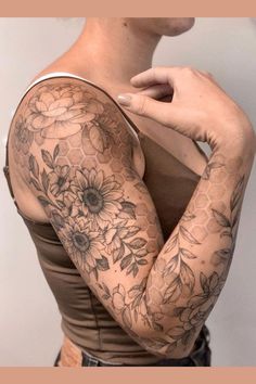 a woman with tattoos on her arm and shoulder