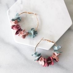 Our Anielle Flower Hoops Earrings have romantic flower petals hung on a dainty hoop. Adorn your outfit any time of the year with a splash of spring vibes with these earrings. They will look perfect with your every day tee and jeans as well as a lovely, flowy dress. Diameter about 1.5 in Trendy Flower Shaped Hoop Earrings Gift, Trendy Flower Hoop Earrings, Chic Summer Jewelry With Flower Charm, Feminine Petal-shaped Jewelry For Spring, Spring Chic Jewelry With Flower Decoration, Chic Spring Jewelry With Flower Decoration, Spring Trendy Dangle Hoop Earrings, Trendy Dangle Hoop Earrings For Spring, Trendy Spring Dangle Hoop Earrings