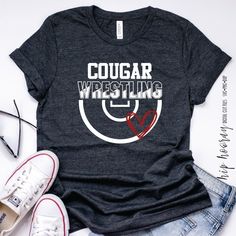 a t - shirt with the words cowboys wrestling on it and a pair of sneakers