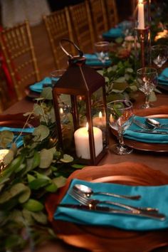 a table set with place settings and candles