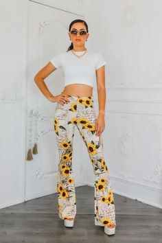 "Leave a love letter in every step with these buttery soft Sunflower Bell Bottom Pants. Flowing like a love letter, these pants offer unmatched comfort and style. Spread love with every wear. Spread good vibes (and fashion) with these bell bottoms!" Model is 5”4 and wearing 5 inch heels: wearing a size small. Great stretch. Trendy Floral Print Bottoms For Loungewear, Fitted Floral Print Pants For Day Out, High Waist Floral Print Bottoms For Loungewear, Trendy Printed Bottoms For Day Out, High Waist Floral Print Loungewear Bottoms, Trendy Printed Bottoms With Relaxed Fit, Trendy Relaxed Fit Printed Bottoms, Trendy Long Bottoms With Floral Print, Trendy Long Floral Print Bottoms