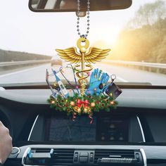 a car dashboard with a christmas decoration hanging from it