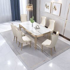 a dining room table with white chairs around it