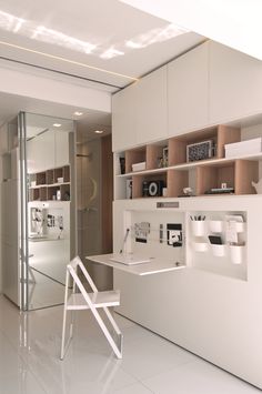 an office with white walls and shelves filled with items