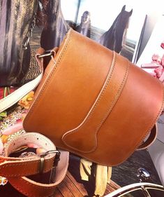 This is a Leather Handmade Cross-body Bag in 4 colors, Natural Tan, Black, Vintage Brown and Brown. It has two inner compartments and secures with a metallic clasp. The strap is adjustable for your shoulder. Width: 6.3 inches (16 cm) Height: 6.3 inches (16 cm) Depth: 1.8 inches (4.5 cm) Natural vegetable tanned leather will age and darken with the sun just like your own skin. Sun exposure and daily handling will give natural vegetable tanned leather a rustic look over time. TOP QUALITY - The Lea Saddle Bag With Detachable Strap For Daily Use, Brown Saddle Bag With Detachable Strap, Daily Use Saddle Bag With Adjustable Strap, Cognac Saddle Bag With Removable Pouch, Saddle Bag With Removable Pouch, Saddle Bag With Removable Pouch For Daily Use, Daily Use Saddle Bag With Removable Pouch, Brown Saddle Shoulder Bag With Removable Pouch, Brown Saddle Bag With Removable Pouch