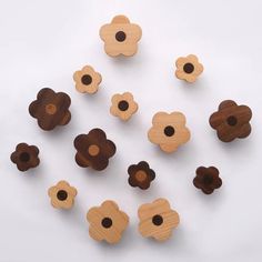 several wooden flowers are arranged on a white surface