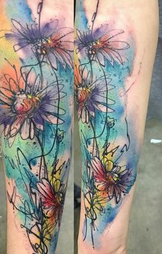 the legs are decorated with colorful flowers and watercolors on them, as well as ink