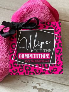 a pink and black leopard print towel with a tag that says wipe out the competition