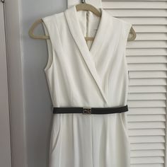 Calvin Klein's Lapel-Collar Jumpsuit Takes A Cue From Tuxedo Suiting, With A Sleek Logo Belt For Polish. Surplice Neckline With Lapel Collar; Exposed Back Zip Closure Removable Logo Belt With Gold-Tone Hardware Pockets At Hips Polyester; Belt: Polyurethane Dry Clean Imported Black Jumpsuit On Model For Reference White Sleeveless Jumpsuits And Rompers For Formal, White Sleeveless Jumpsuits And Rompers For Formal Occasions, White Sleeveless Jumpsuit For Formal Occasions, White Fitted V-neck Pantsuit, Elegant Fitted Belted Pantsuit, Formal Belted Sleeveless Jumpsuits And Rompers, White Belted Jumpsuits And Rompers, Sleeveless Belted Formal Jumpsuits And Rompers, Sleeveless Belted Formal Jumpsuit