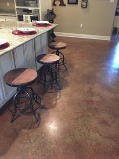 three stools sit in the middle of a kitchen