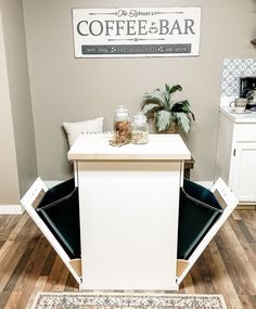 a coffee bar with two chairs in front of it and a rug on the floor